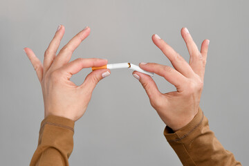 Close-up of a female hand breaking cigarette 