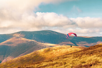 Paragliding active sport against giant mountains in highland