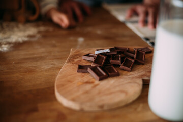 squares of chocolate on the table on a wooden board in the form of a heart