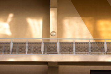 the sun's shadows are reflected on the balcony of the house. Bright sunny day