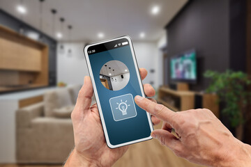 Man using smart home app to turn on light in room by mobile phone
