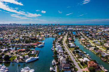 Obraz premium Marco Island Florida Homes And Yachts. Marco Island is a barrier island in the Gulf of Mexico off Southwest Florida, linked to the mainland by bridges south of the city of Naples.