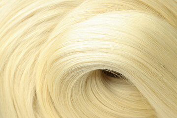 Blonde female hair on whole background, close up