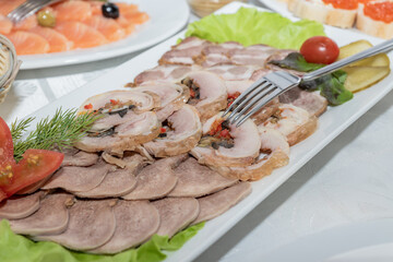 Delicatessen assortie on a plate at the restaraunt. Meat appetizer selection.