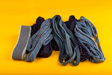 Colorful fabric accessories or pieces standing on a yellow background. accessories and rubber threads used in textile production