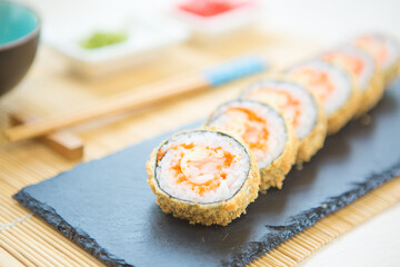 Maki roll with salmon, popular Japanese cuisine. Sushi roll with fish, cream cheese and vegetables