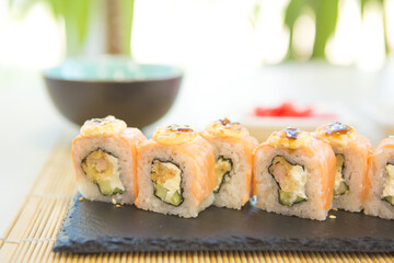 Maki roll with salmon, popular Japanese cuisine. Sushi roll with fish, cream cheese and vegetables