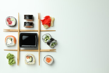 Concept of tasty food with sushi rolls on white background