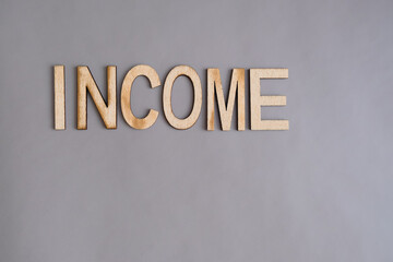 the word income on grey texture background. profit business revenue