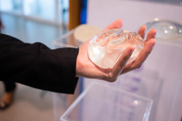 A young man is experimenting with breast augmentation silicone for cosmetic surgery.