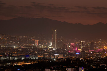 Obraz premium Night view of Izmir city from a distance. City Lights of Izmir downtown at night. Izmir is the third biggest city of Turkey.