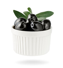 Black olives with leaves in bowl isolated on white background with clipping path.