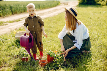 Beautiful mother with little son in a summer field