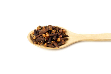 Cloves on wooden spoon isolated on white background. Herbal cloves have a fragrant and spicy flavor.