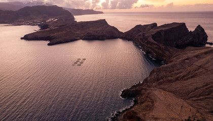 Scenery of fishing farm near rocks in sea