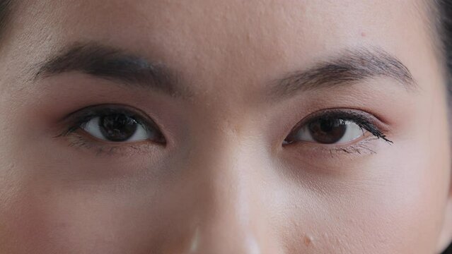 Female dark black clear eyes young asian korean girl looking at camera woman with good vision sight eyesight with long eyelashes natural make-up look see after successful laser surgery ophthalmology