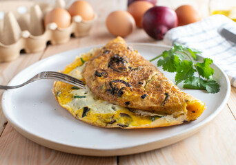 Omelette with roasted red onions, chives and cheese. Low carb breakfast