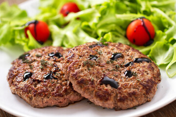 Homemade Hamburgers with Green Salad on a Plate.
