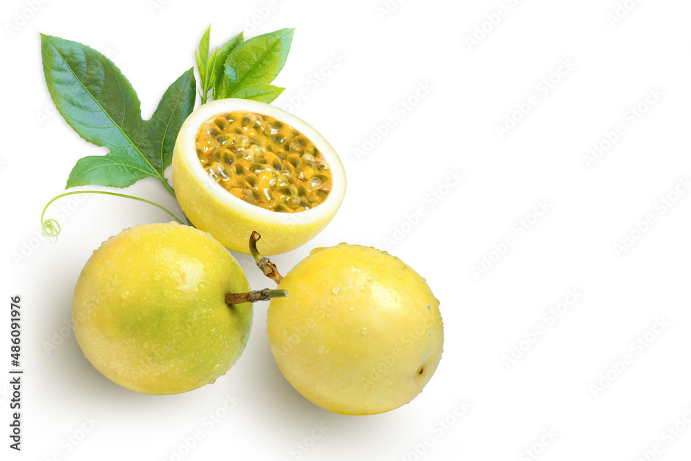 Wall mural yellow Passion fruit (passionfruit) with water droplets and green leaves isolated on white background.  - Wall murals