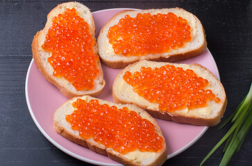 Naklejka na ściany i meble sandwiches with red caviar. Serving a delicacy on a plate