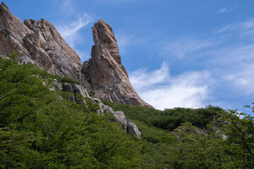 View of the forest and rocky formations under a deep blue sky. 