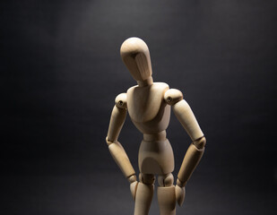 The wooden mannequin ,tired. on a black background