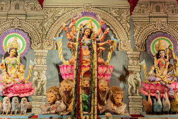 Goddess Durga idol at decorated Durga Puja pandal, at Kolkata, West Bengal, India. Durga Puja is biggest religious festival of Hinduism and is now celebrated worldwide. - obrazy, fototapety, plakaty