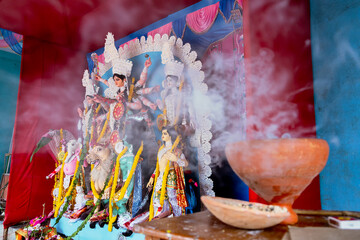 Holy smoke covering part of Goddess Durga idol at decorated Durga Puja pandal, at Kolkata, West...