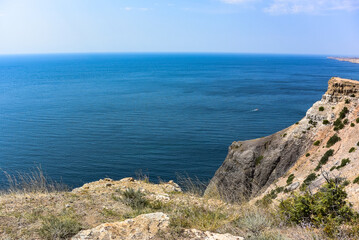 Fototapeta na wymiar Cape Fiolent in Balaklava, Russia. View from the top of the cliff. azure sea, sunny day against a clear sky.