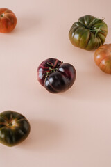 Tomatoes of different varieties and different colors. On a warm colored background, isolated. Close up. Still life.