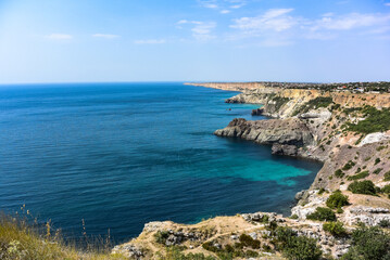 Fototapeta na wymiar Cape Fiolent in Balaklava, Russia. View from the top of the cliff. azure sea, sunny day against a clear sky.