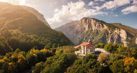 Aerial drone panoramic view of a little church on a cliff in deep canyon near legendary Mountain...