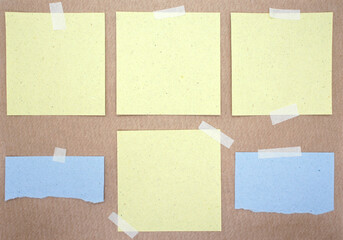 Set of square and torn paper notes with sticky tape. Collection of yellow and blue paper sheets on kraft paper background. Mockup for design. Blank templates. 