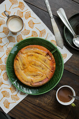 Caramel banana cake with caramelized sesame seeds on a green ceramic plate. Delicious simple sweet dishes for tea. Family Traditional Recipes