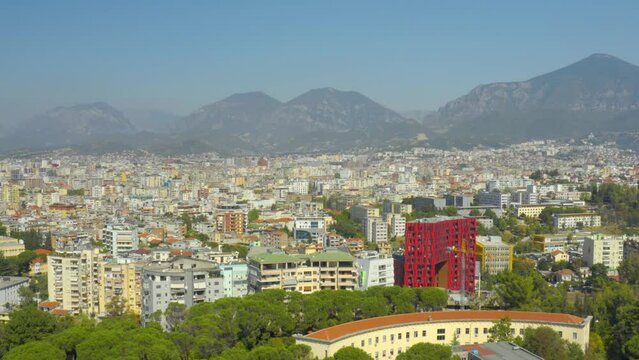 A drone view of the skyline of Tirana, Albania. Residential areas, buildings, mountains, city panorama, drone view - 4K Drone Video Footage