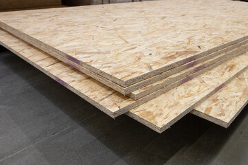 OSB pressed wood sheets stacked in store. Construction materials
