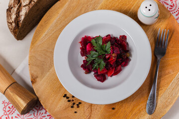 beetroot vinaigrette on a white plate and wooden background