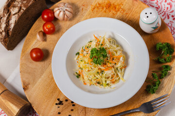 vegetarian cabbage and carrot salad on a white plate