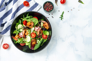 Seafood salad with smoked shrimps, cherry tomatoes, cucumber and mixed leaves. Healthy eating concept. Detox diet. Vegetarian lunch. Weight loss, top view