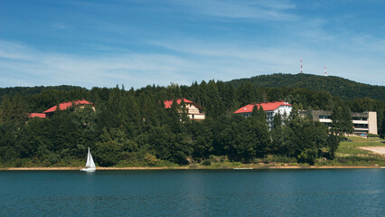 Fototapeta na wymiar Sailboats on Lake Solina in the Bieszczady Mountains