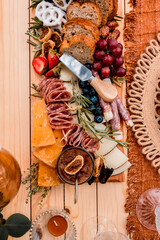 Charcuterie picnic board and small cake overhead details 