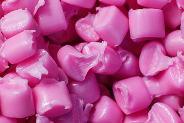 Pink granules of polypropylene or polyamide. background. Plastics and polymers industry. Monochrome...