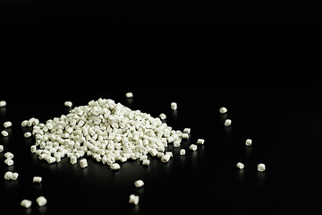 white granules of polypropylene, polyamide in a test tube. Background. Plastic and polymer industry. Microplastic products.