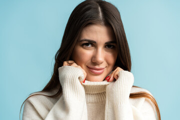 Positive beautiful young woman smiling positively while looks at camera with carefree face expression