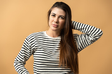 Bright lady looking at the camera isolated on orange background