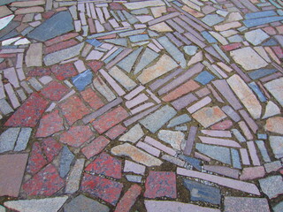 The mosaic paving of the site (breccia) is made of natural stone of various shapes, shades and rocks.