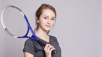 A pretty, athletic female tennis player isolated on a white background.