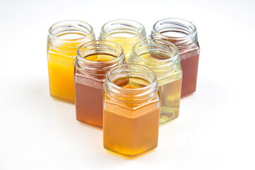 Hexagonal jars with different types and colors of fresh flower honey. vitamin food for health and life