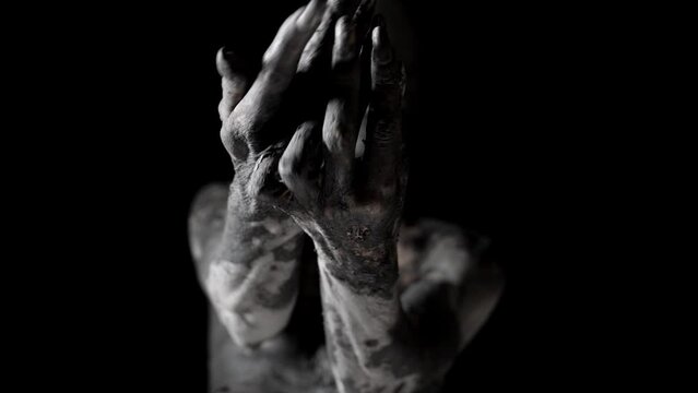 enigmatic clay statue of blindfolded woman is stretching hands to camera
