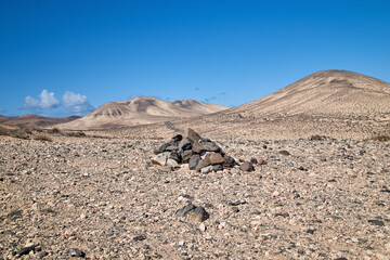 typical cairn marking and landscape in the interior of the Canary Island of Fuerteventura